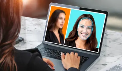 Woman browsing her laptop, detecting possible deepfake frauds