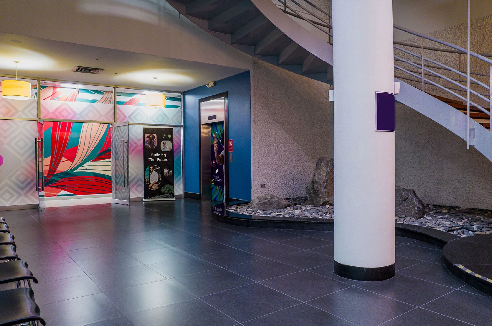 TP office lobby with modern design, colorful wall art, and seating area near the elevator.