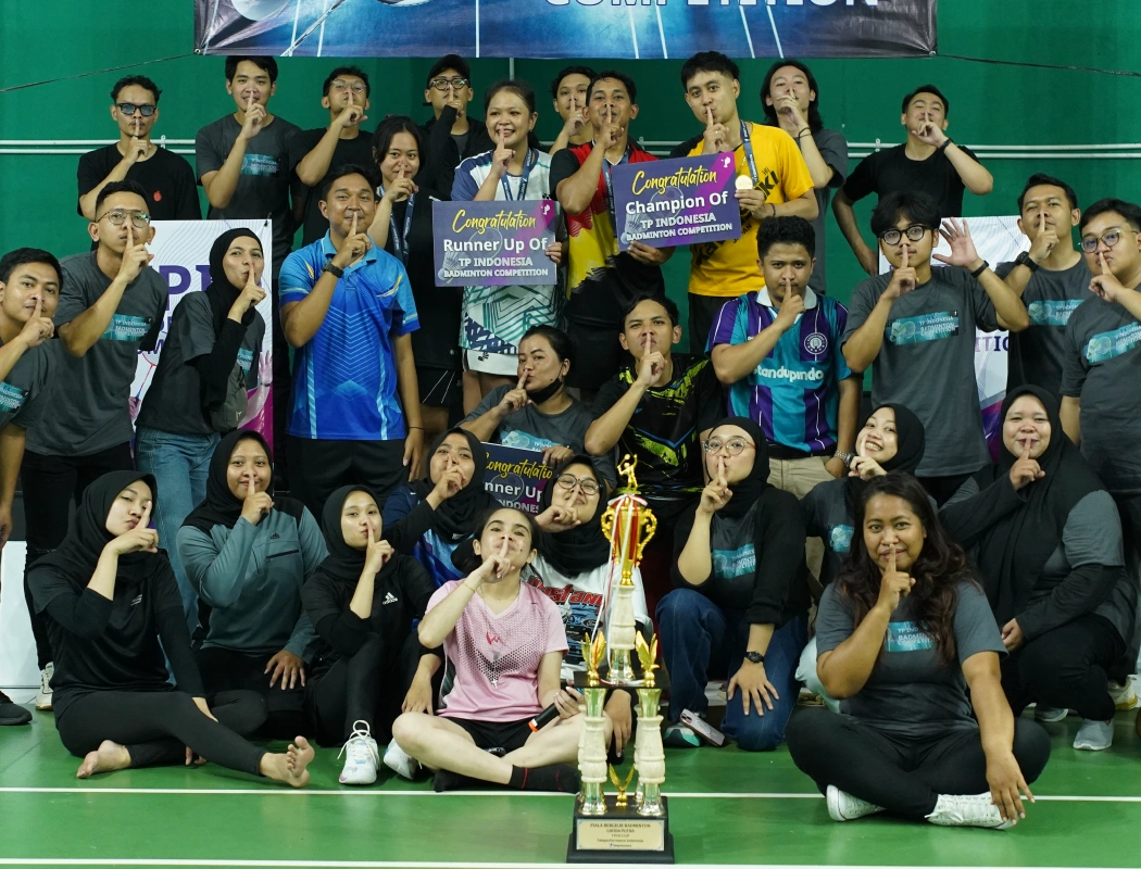Team celebrates victory at the TP Indonesia badminton competition.