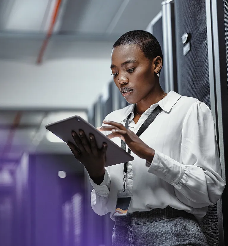 Afro descendant professional working in a modern data center environment.