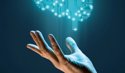 An open palm holds a glowing circuit brain symbolizing artificial intelligence technology.