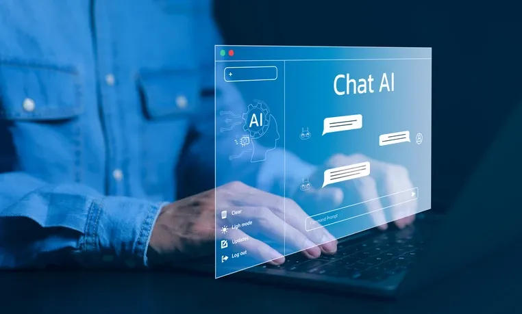 Person typing on a laptop with a virtual holographic interface displaying 'Chat AI' and chat bubbles, symbolizing artificial intelligence conversation technology.