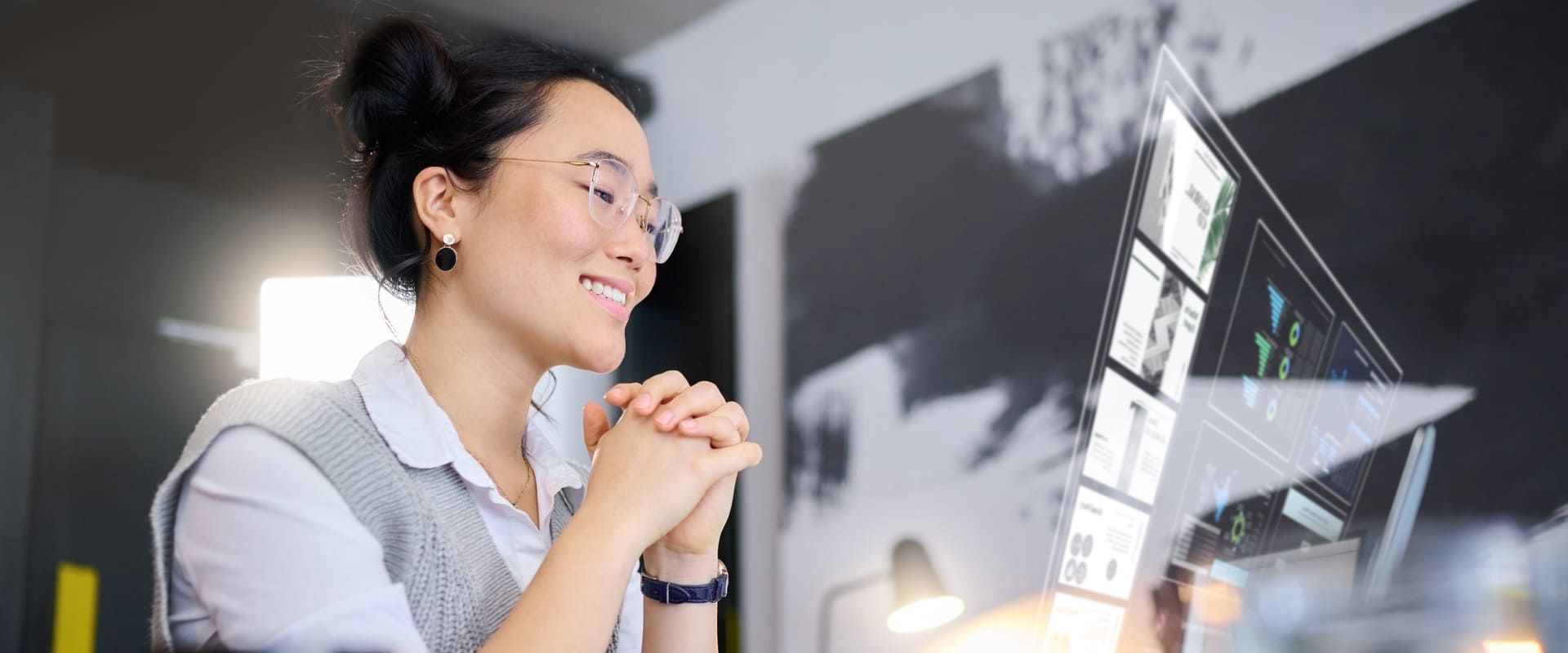 Asian woman interacting with a 3D holographic screen, illustrating a blog about AI trends.