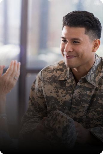 Smiling person in military uniform during a job interview conversation.