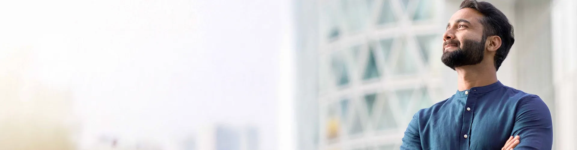 Business professional looking upward with a confident and satisfied expression.