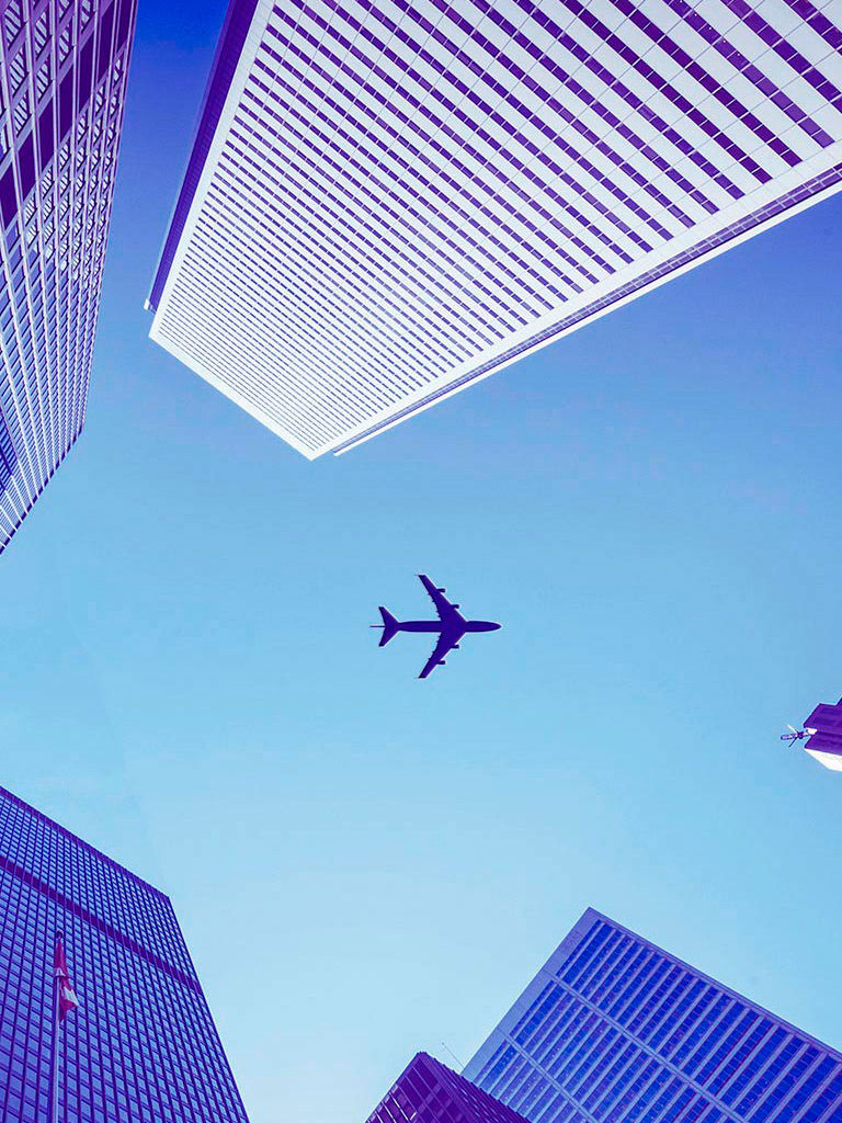 Airplane flying over the city.