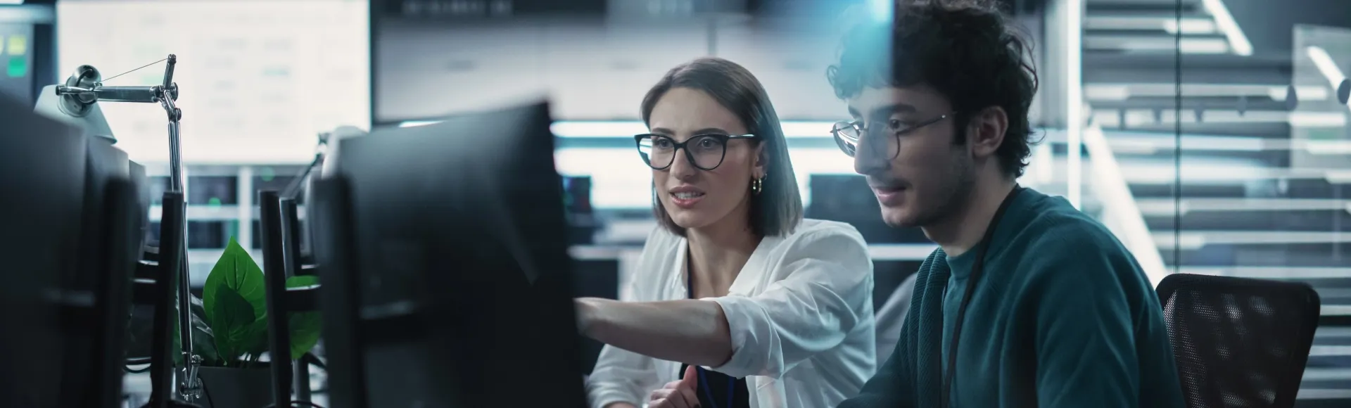 Colleagues working together on a company computer.