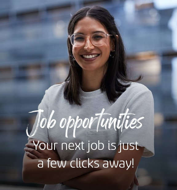 A person smiles confidently with arms crossed, standing against a blurred building background. overlay text reads: "job opportunities. your next job is just a few clicks away!