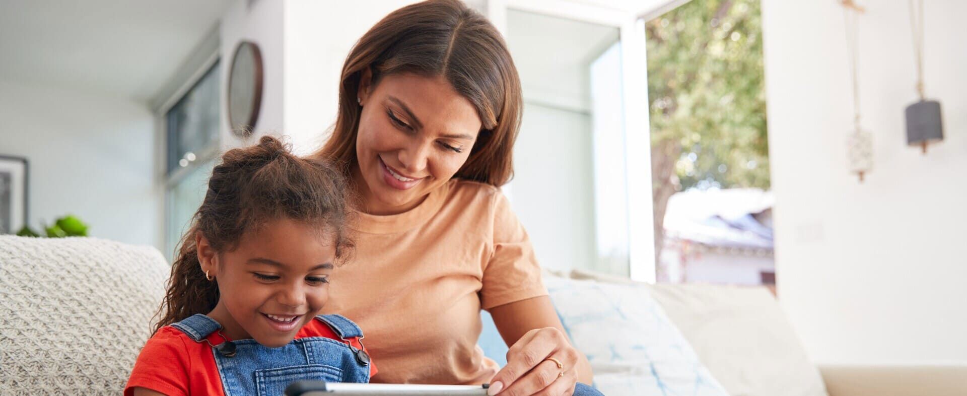 Woman caring for a child, illustrating PR on supporting 60,000 children, including 10,000 from India, in 2022