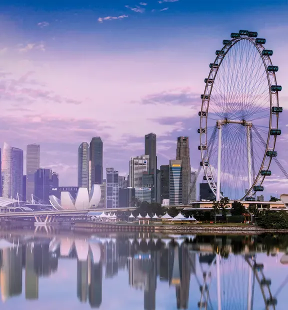 Singapore skyline with Marina Bay Sands, waterfront buildings, and the Singapore Flyer.