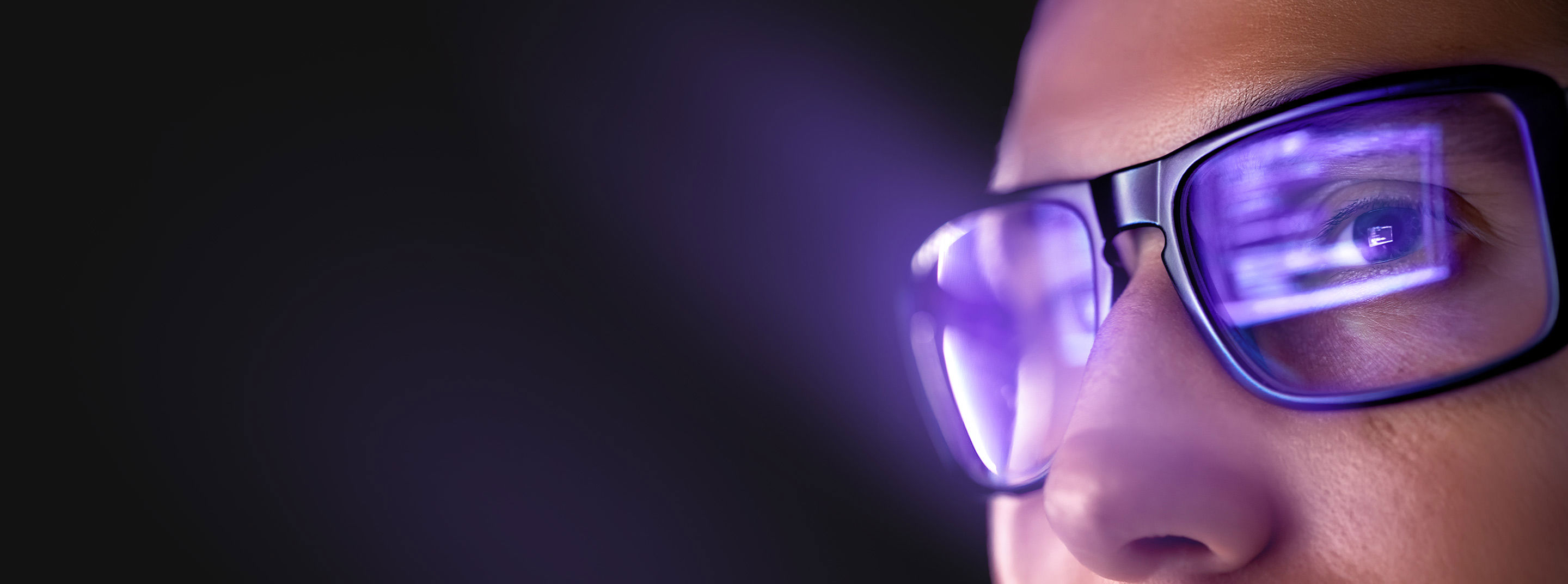 Person wearing glasses viewing digital data on screen for TP intelligent services.