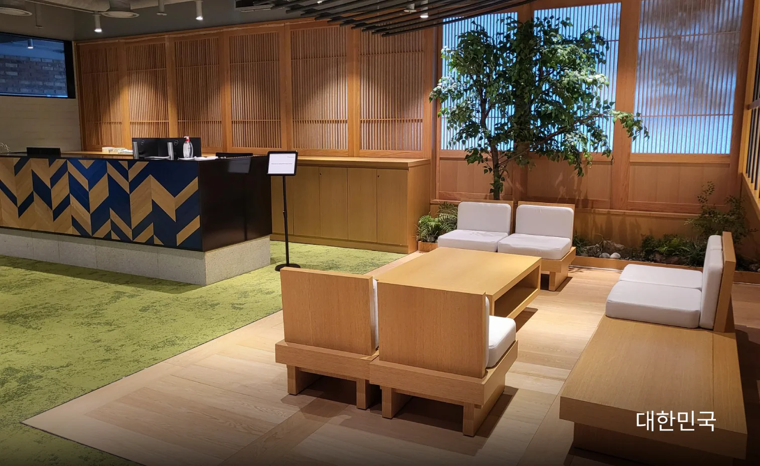 There are tables and chairs in the reception waiting area.