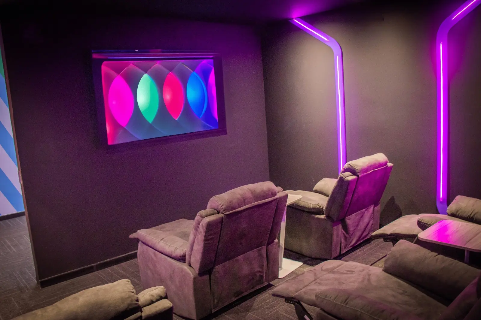TP relaxation room with recliner chairs and colorful LED lighting for employees to unwind.