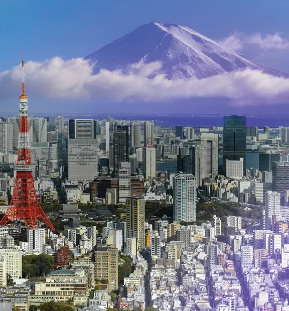 Tokyo cityscape with Tokyo Tower, high-rise buildings, and Mount Fuji.