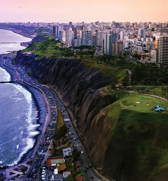 Lima cityscape along the Pacific coast with cliffs, parks, and high-rise buildings.