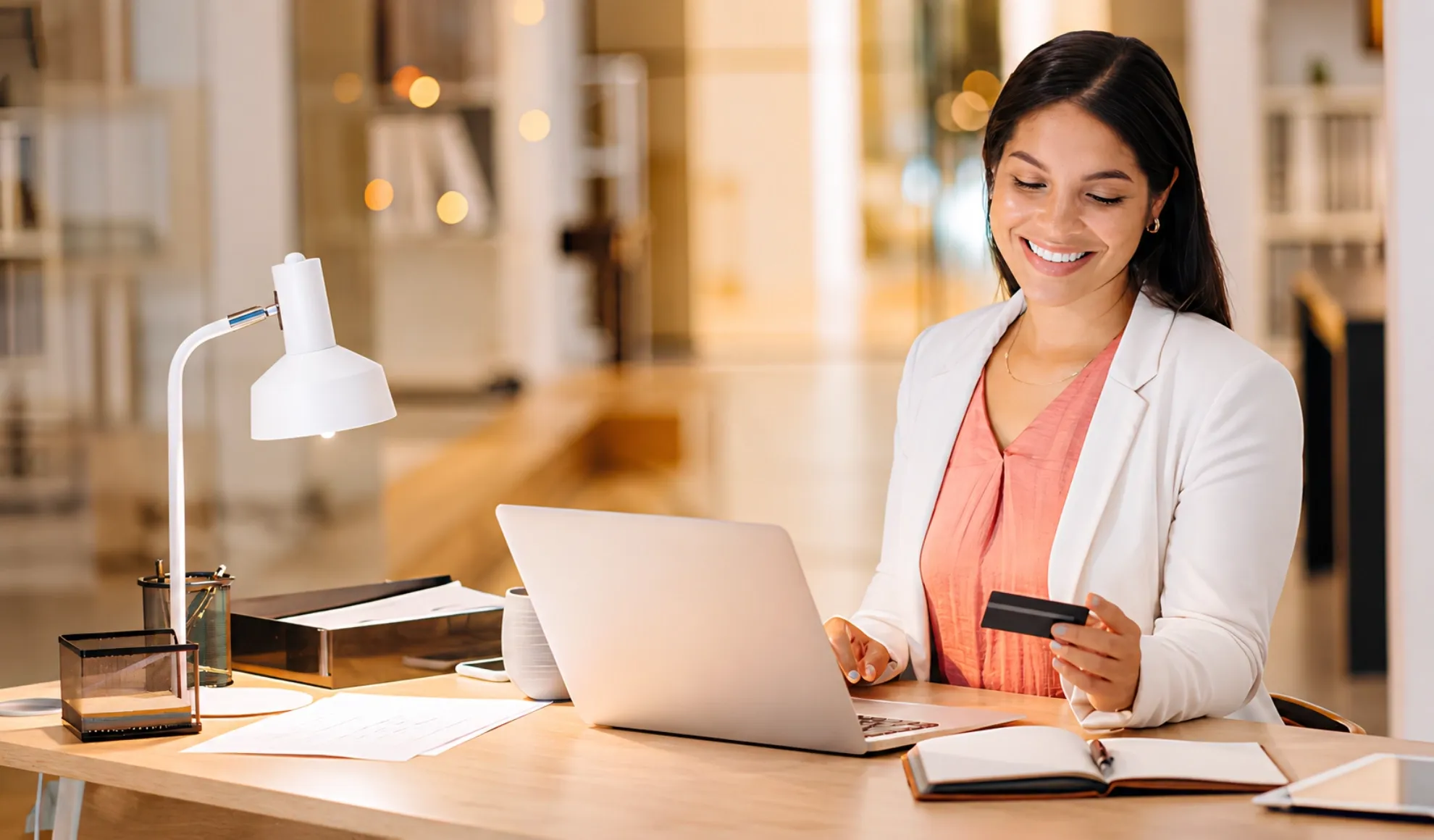 Businesswoman using a credit card to complete an online purchase.