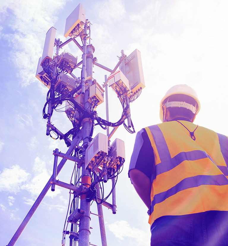 Man working on a transmission tower.