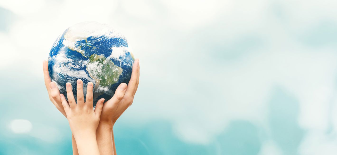 Hands holding a globe symbolizing global unity and care for the planet.