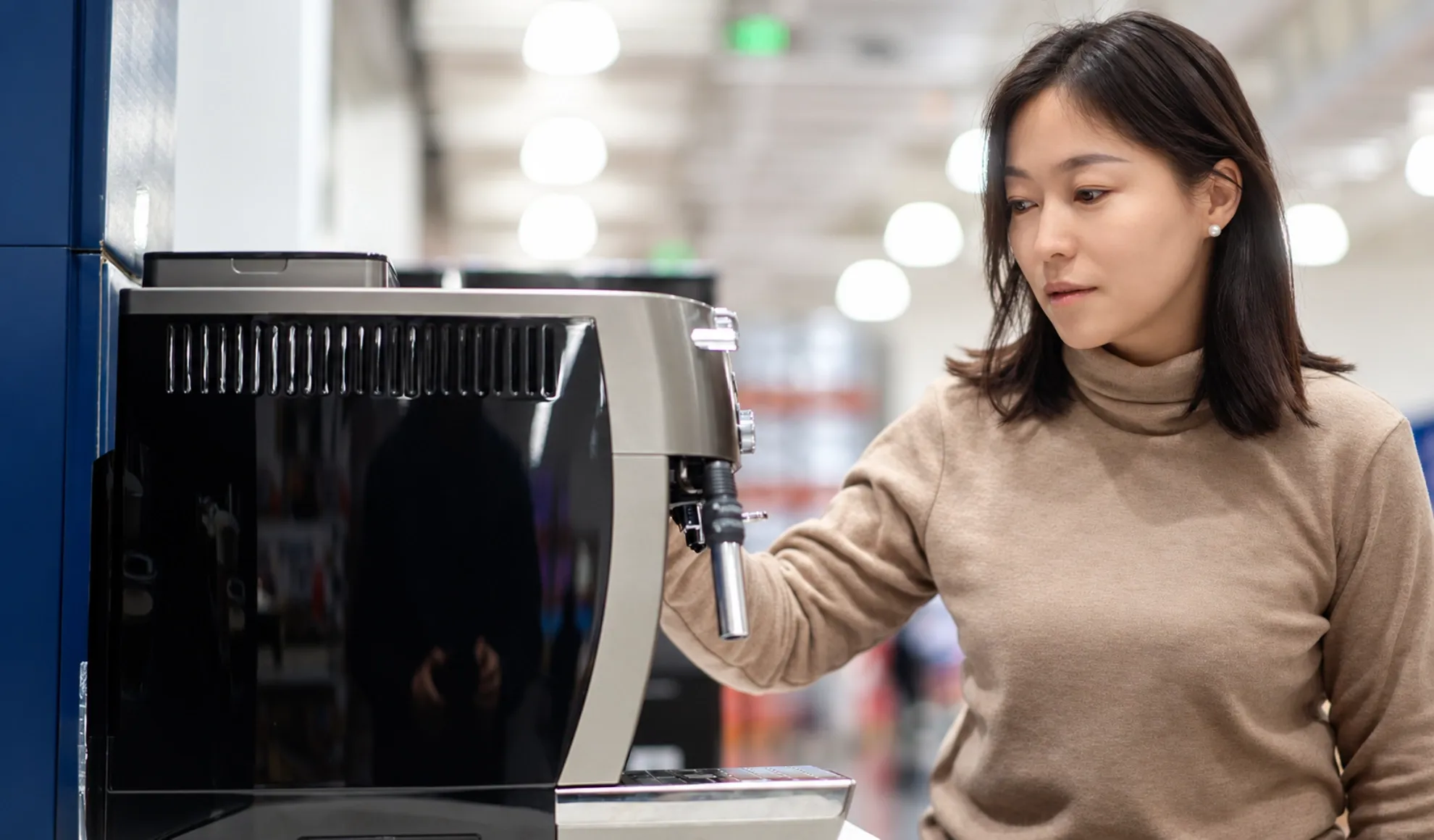 Asian woman browsing products in a store, illustrating the customer journey.