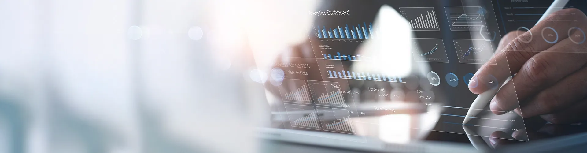 Person analyzing data on a transparent digital dashboard.