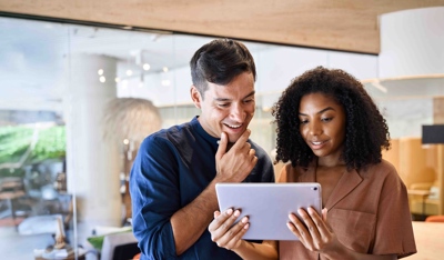 Couple working on a tablet at the office