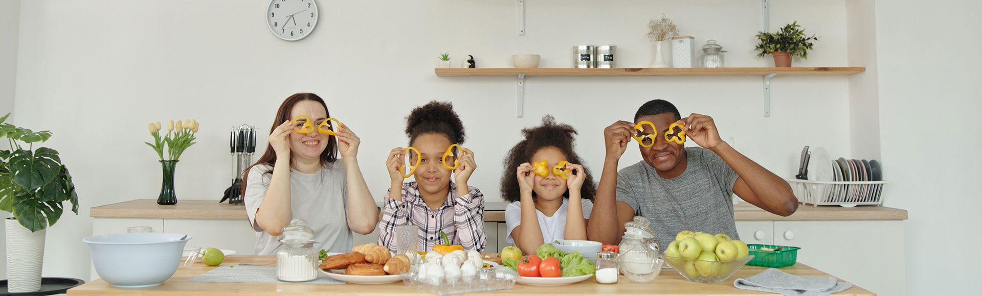 An Afro-descendant family cooking together and enjoying a pleasant moment at home.