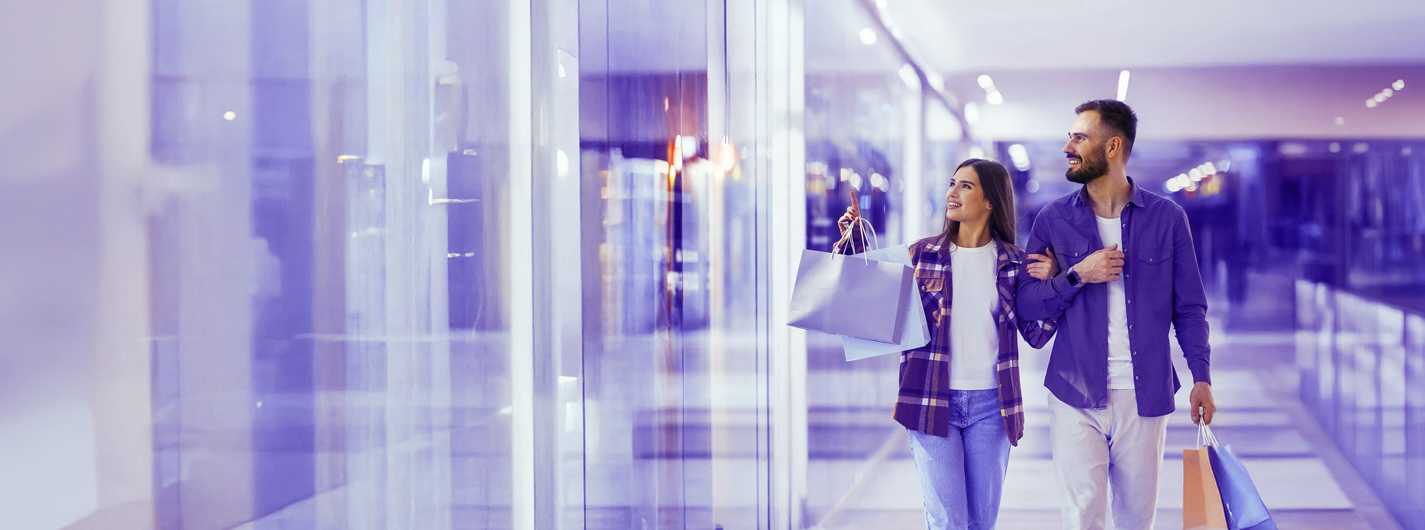Couple enjoying a shopping experience together in a modern retail mall.
