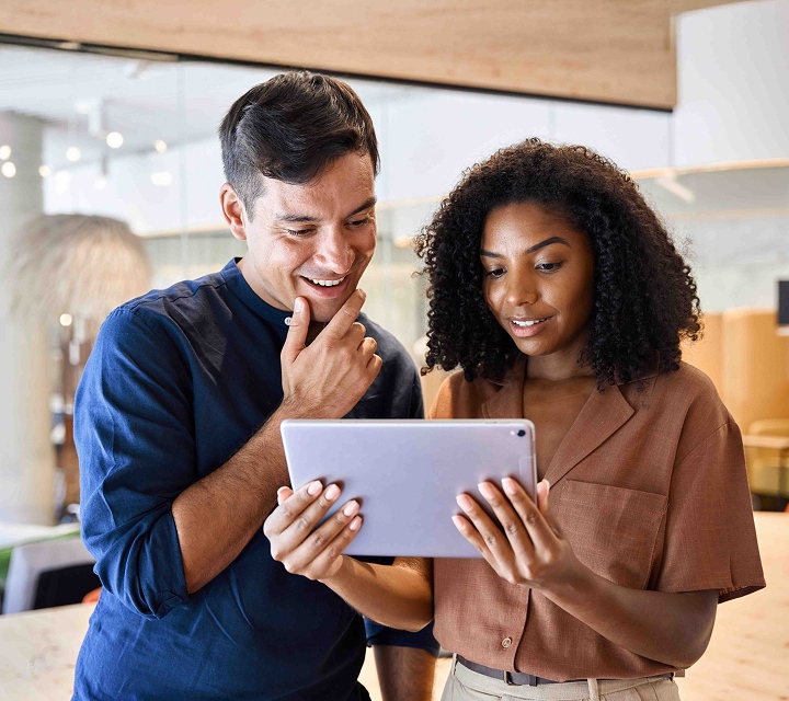 Two colleagues looking at a tablet