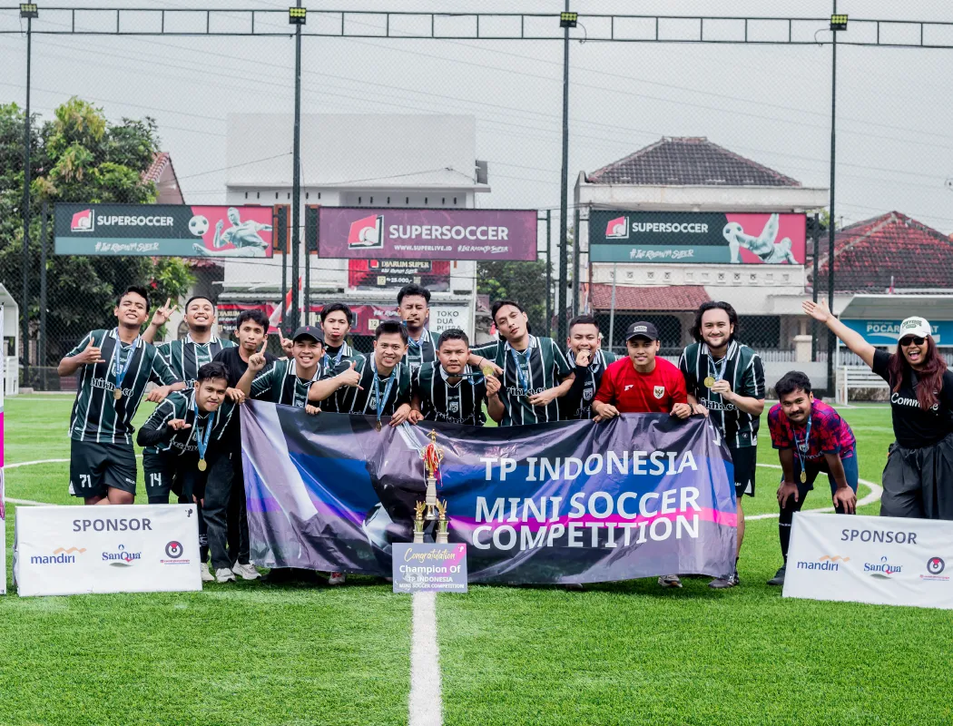 A team celebrates winning the TP Indonesia mini soccer competition.
