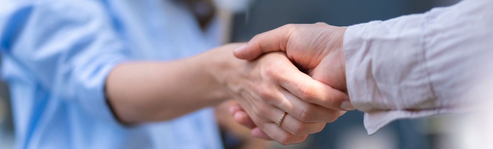Businesspeople shaking hands, symbolizing partnership and successful collaboration.