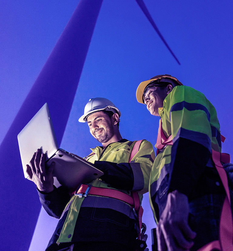 Wind power operators working on computer.