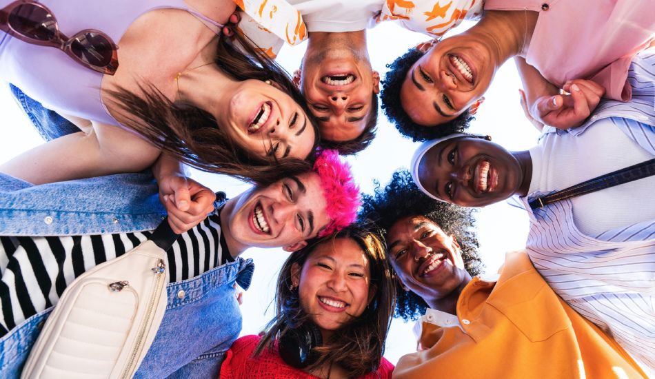 Diverse group of smiling young professionals in a positive work environment.