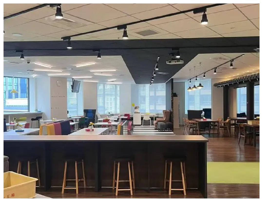 A bright, modern open office with various seating and workspaces.
