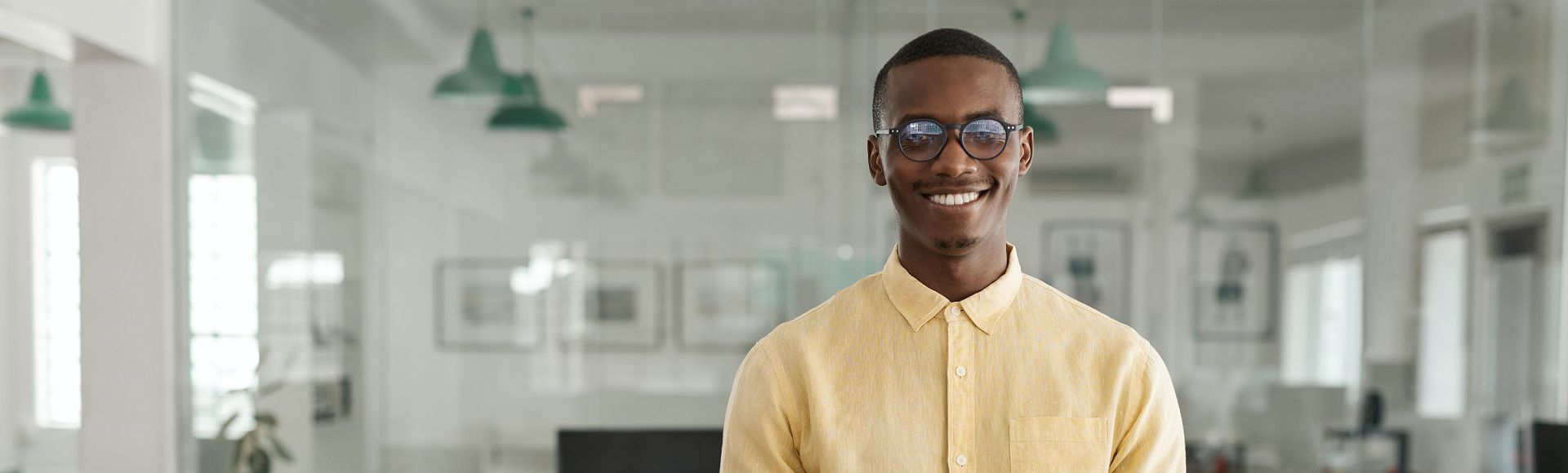 Smiling young Afro descendant professional in a business setting.