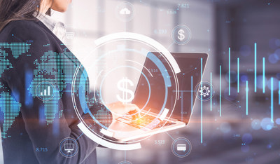 A businesswoman uses a laptop, surrounded by glowing fintech and global digital data overlays