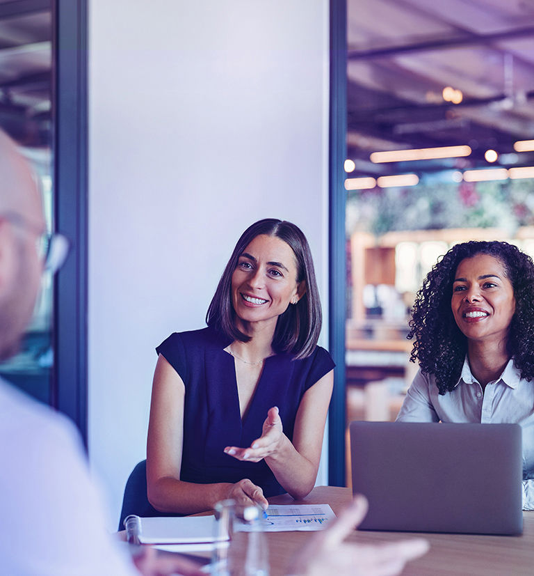 Professionals discussing business solutions in a modern office.