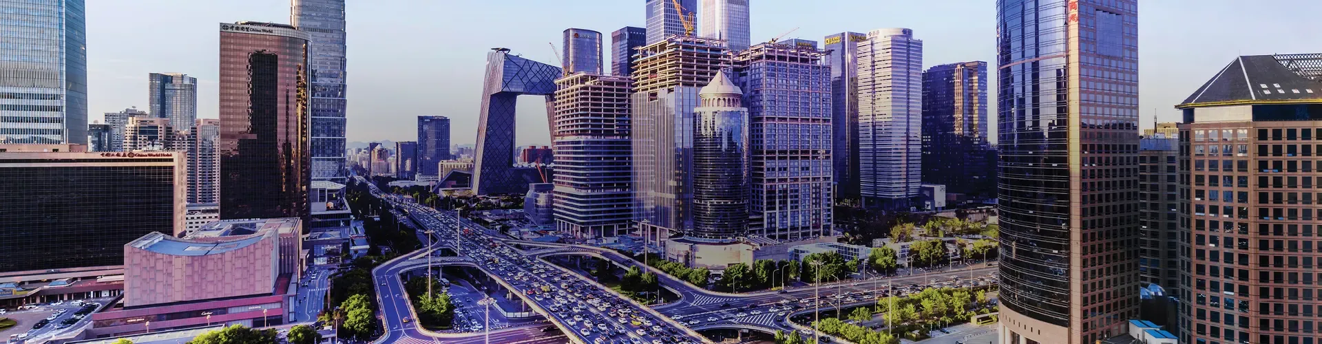 Beijing cityscape with modern skyscrapers and busy multilane roads.