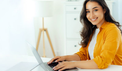 Smiling woman working on her laptop