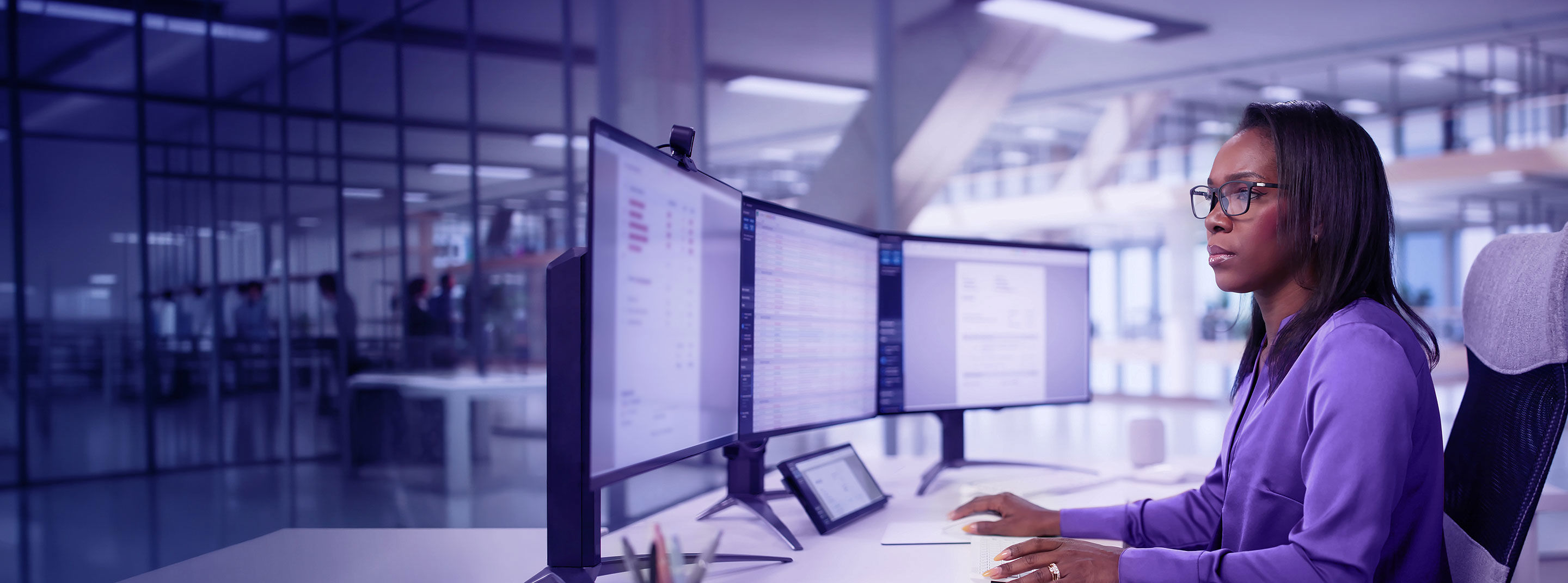 Afro-descendant professional monitoring multiple screens in a high-tech security environment.