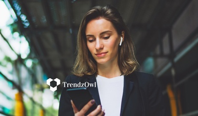 Businesswoman holding her phone, illustrating tech trends to watch in 2026 and beyond.