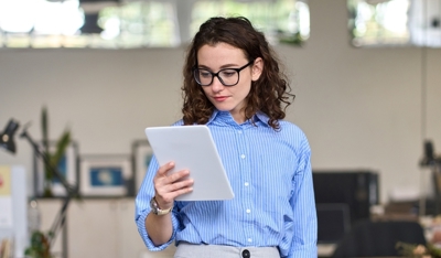 A serious businesswoman working on her tablet