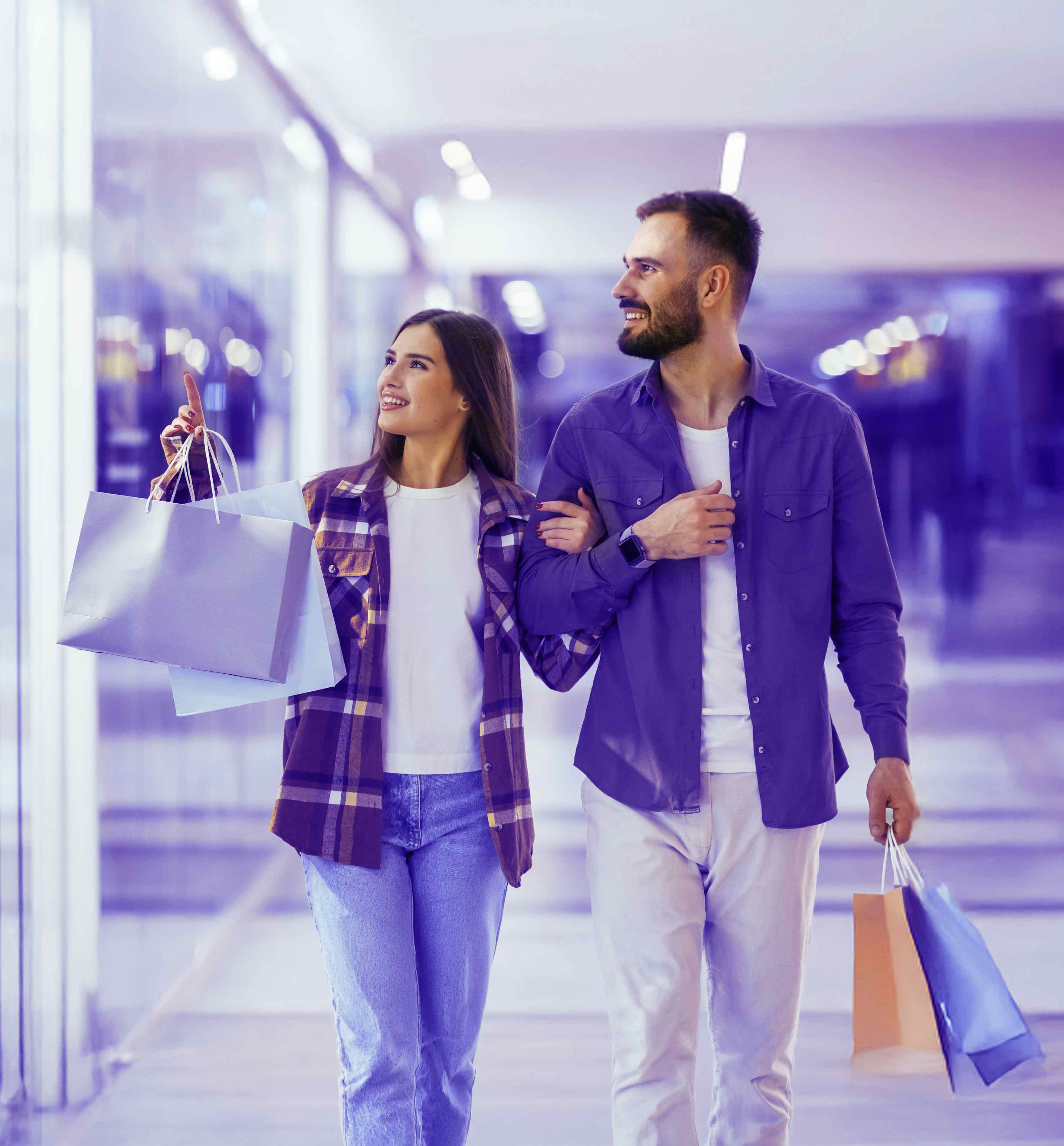 Couple enjoying a shopping experience together in a modern retail mall.
