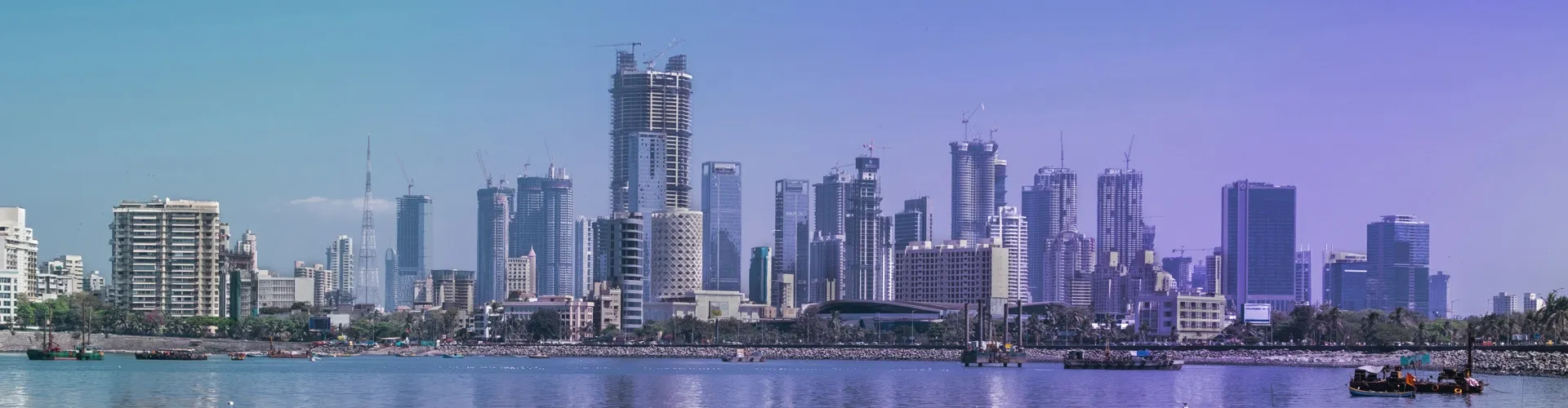 Town skyline with modern high-rise buildings viewed across the waterfront.