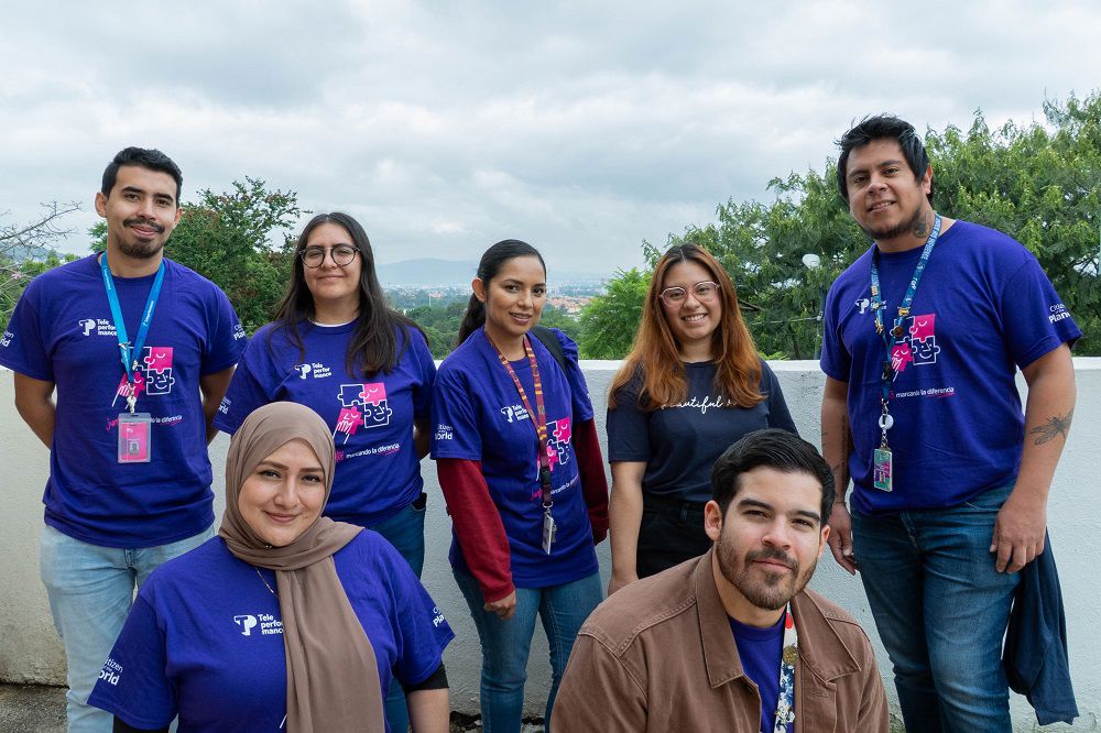 TP colleagues in Mexico pose wearing shirts from the Teletón partnership.
