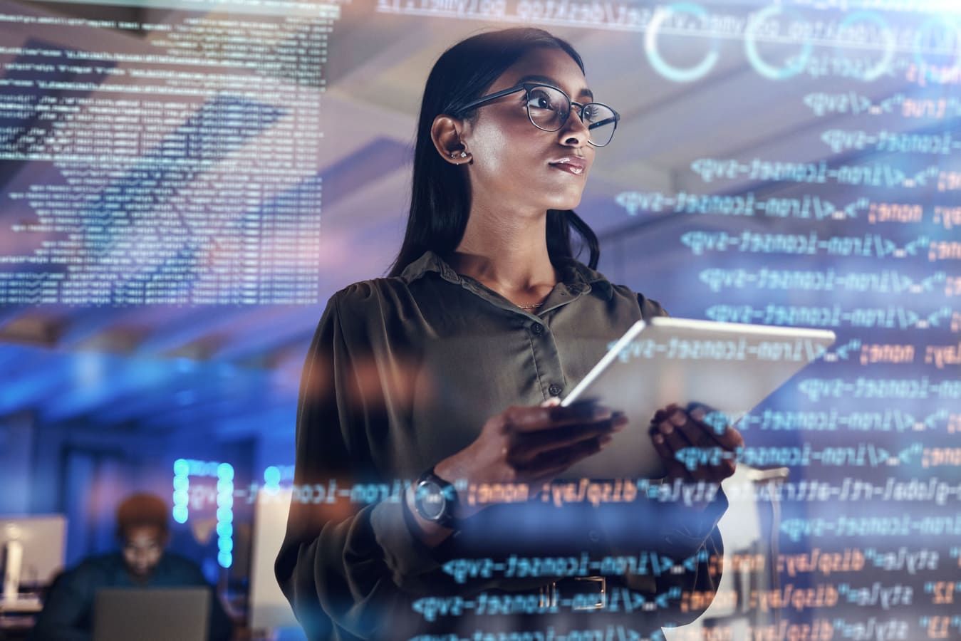 Serious woman holding a tablet with 3D programming codes in the foreground