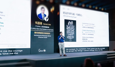 Daniel Wei delivers a keynote speech at a corporate summit on stage.