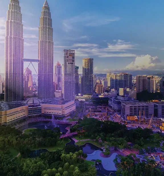 Kuala Lumpur cityscape with modern skyscrapers, parks, and surrounding hills.