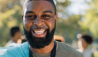 Smiling volunteer engaged in community service and social impact work.