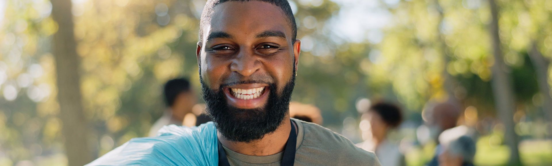 Smiling volunteer engaged in community service and social impact work.