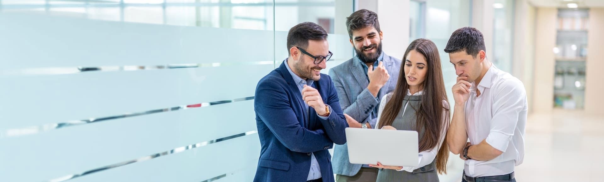 Team of employees collaborating in an office, representing late-stage debt recovery strategies.